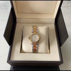 This is a brand new watch with gold and silver.